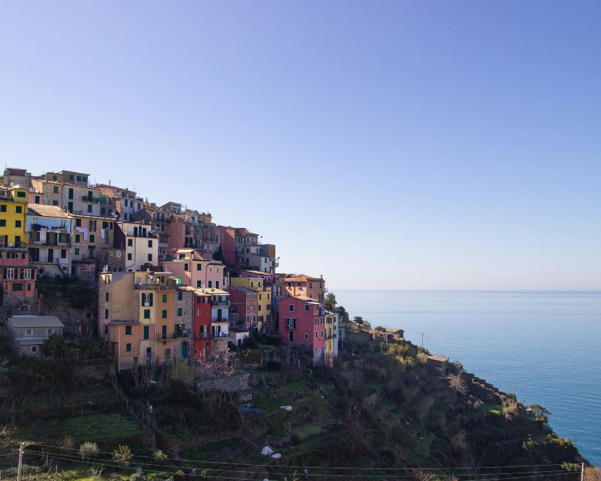 Buildings on side of cliff overlooking ocean
